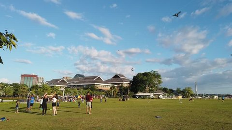 BANDAR SERI BEGAWAN,BRUNEI - CIRCA JANUARY,2018 : 4k footage people playing kites and bubbles on a field at Taman Mahkota Jubli Emas.