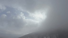 Mountain top in the mist by winter 4K drone footage