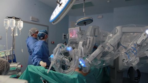 Doctors using surgery robot in surgical room in hospital with robotic technology equipment, machine arm surgeon in futuristic operation room. Medical robot surgery 3D view 