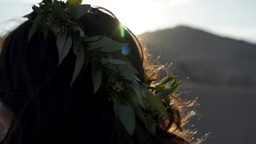 Close up of a beautiful crown of leaves on the head of a bride on a bright summer day.