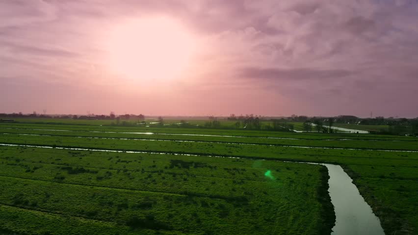 flying over a beautiful spring green fields in a rural landscape, canals in Waterland, Netherlands, Holland Royalty-Free Stock Footage #1022326360