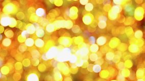 Abstract video of golden shining and glittering big circles bokeh blurring background design.