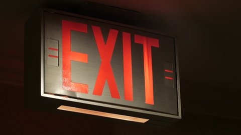 Glowing red exit sign close up