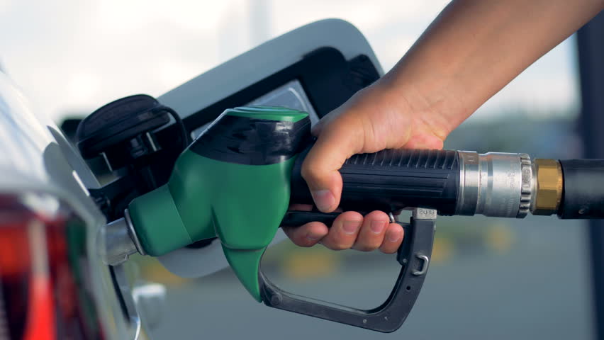 An automobile is getting refueled by a petrol pistol  | Shutterstock HD Video #1022334361