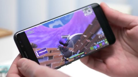 MONTREAL, CANADA - January 2019 : Smartphone streaming Fortnite online game on Twitch app. Live gaming Competitions