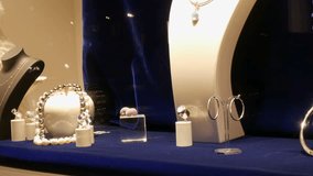 Counter with expensive luxury jewelry made of gold, silver, pearls in the window of a jewelry store