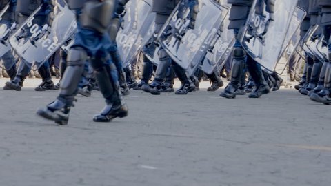 A march of riot police to protect the city