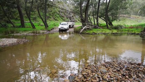 A 4x4 crossing a river in slow motion