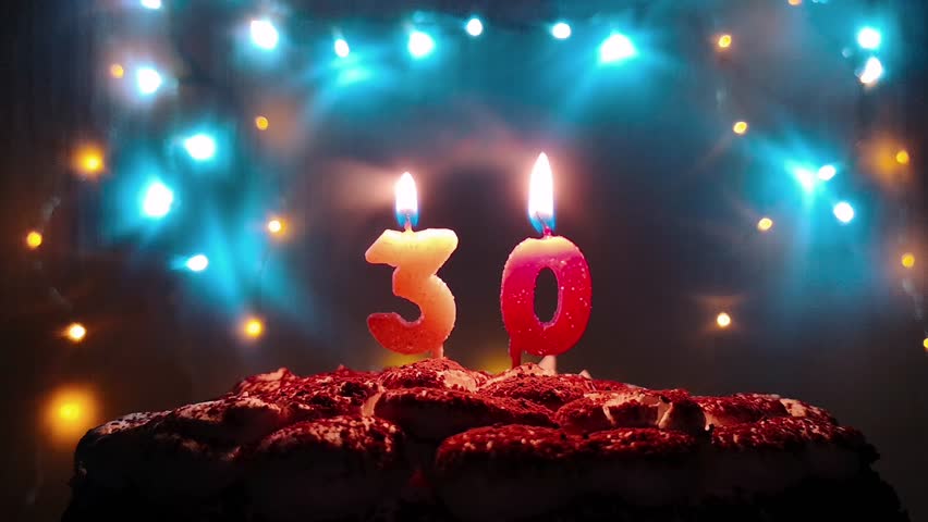 Burning Birthday Candle On a Stock Footage Video (100 Royaltyfree