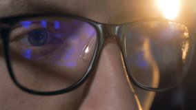 Close up of glasses put on a man with a computer game reflecting in them
