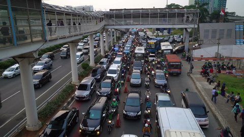 Jakarta, Indonesia - November 15 2018: Traffic jam along the busy Gatot Subroto highway in the heart of Jakarta south business district. The city is known to be very congested. Shot as a time lapse