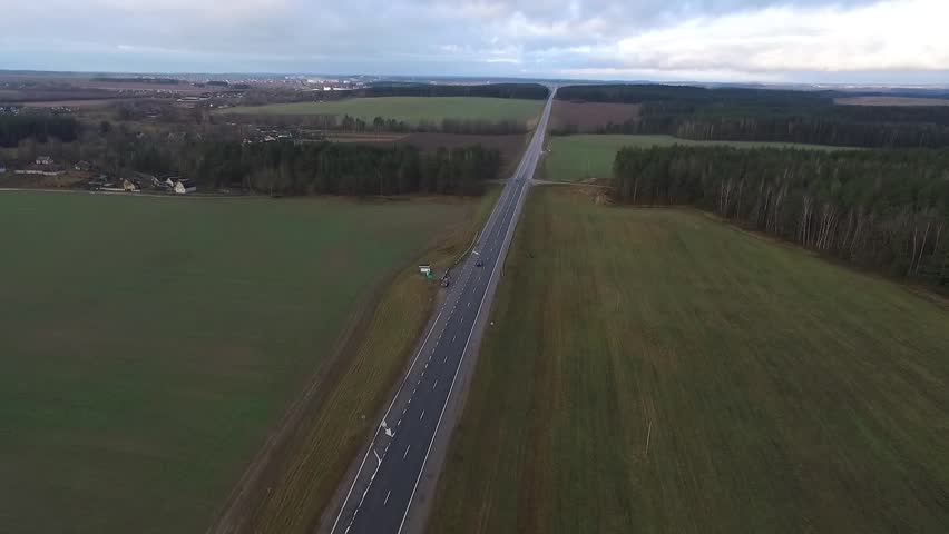 Aerial view of almost empty road it the forest. 2 lanes road.