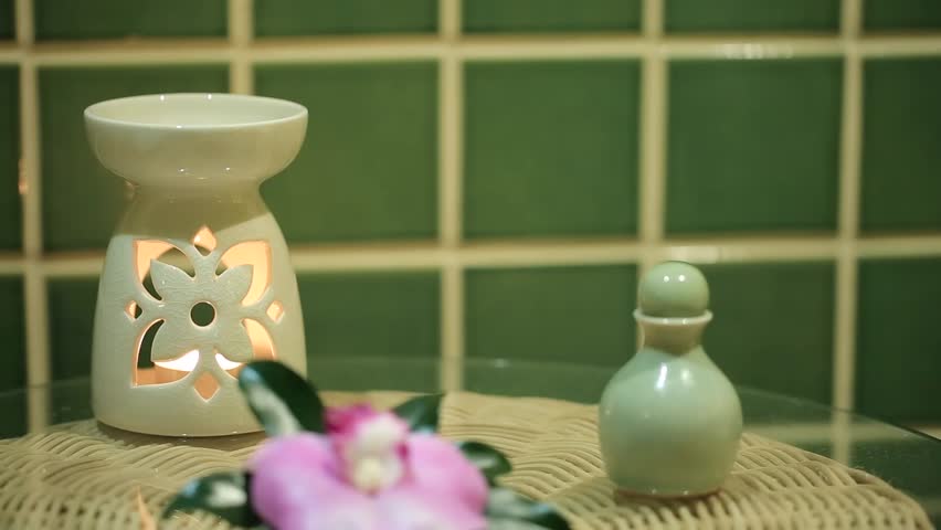 Shampoo or bath soap in ceramic bottle with flower.