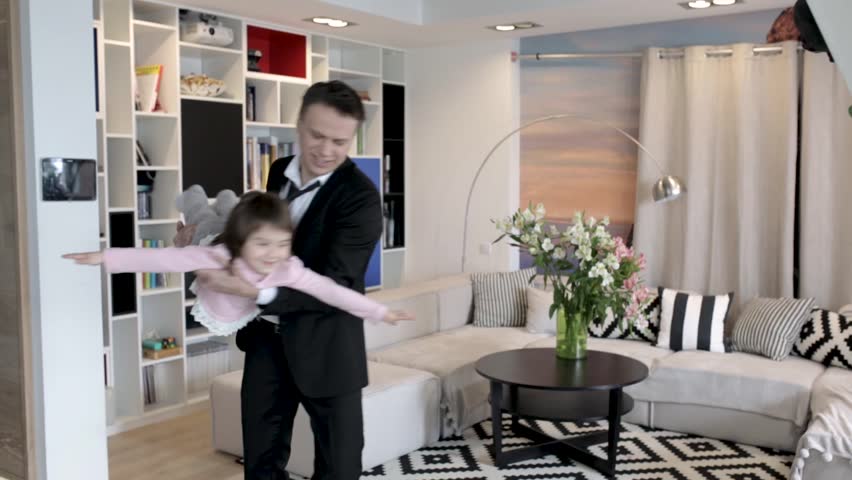 Happy Father In A Suit Holds Her Laughing Daughter. Father