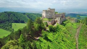 Aerial View beautiful landscape view on castle in field on the mountains background in summer sunny day with blue sky, Drone 4K Video
