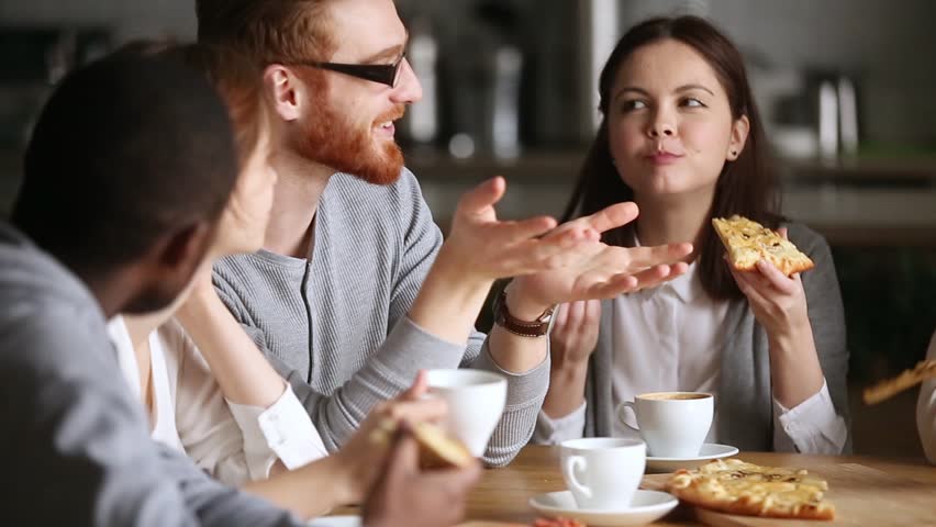 Young multi ethnic friends group talking sharing pizza discussing interesting news hangout, diverse millennial students hanging in cafe eating together having fun conversation laughing in pizzeria Royalty-Free Stock Footage #1022373406