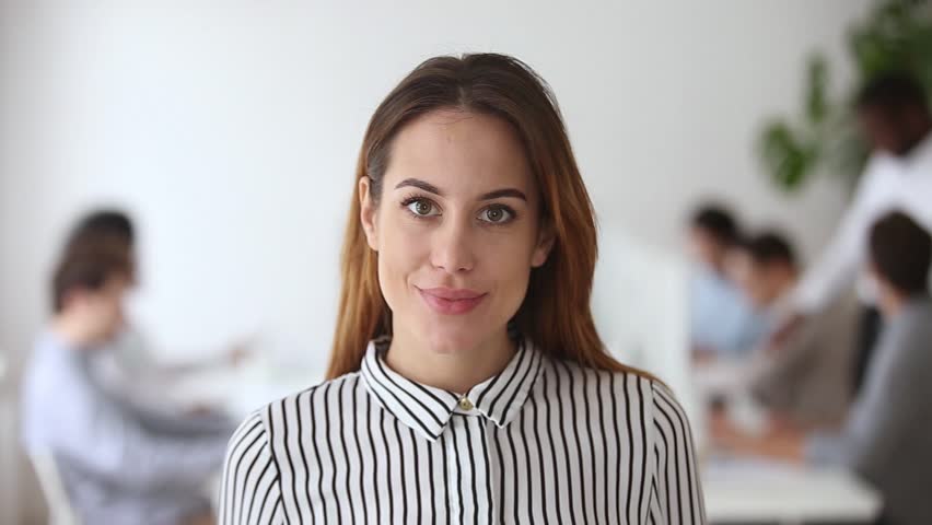 Video portrait of happy female business leader successful millennial businesswoman posing in office with team, smiling professional administrator young executive confident lady boss looking at camera Royalty-Free Stock Footage #1022373427