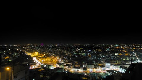 Amman at night, Jordan. Wide shot dolly right, downtown Amman, city center, Hyperlapse with very busyement at night. 4K