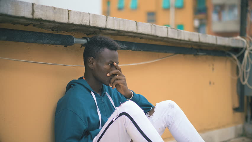 Worried sad youg african american man alone thinking-outdoor