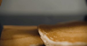 Pancakes fall on each other in slow motion. Video in 4k