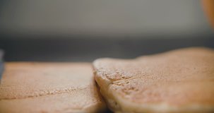 Pancakes fall on each other in slow motion. Video in 4k