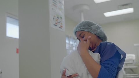 Santo Domingo, Dominican Republic; Dec 21 2017. Mother loads her newborn baby in a hospital. 4K footage.