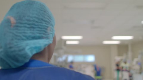Santo Domingo, Dominican Republic; Dec 21 2017. Woman walks through neonatology room to meet nurse. 4K footage.
