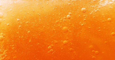 Extreme macro of bubbles in orange gel. 4k.