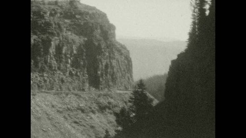 1920s: Sign for Rustic Falls. Water flows over galls. Sign for Obsidian Cliff, elevation 7350.