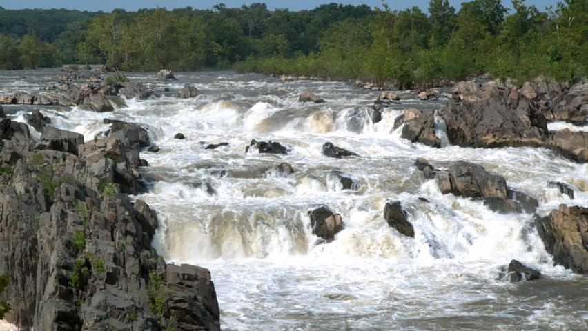 Rushing water through rocks of Potomac River taken in slow motion.