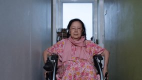 Asian senior woman show Thailand's greeting style on wheelchair