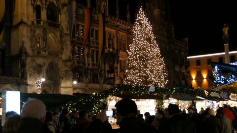 Munich, Germany - December 2, 2018: The main square Marienplatz in the dark, on which stands the Christmas market with many stalls. Crowds of tourists celebrate Christmas.