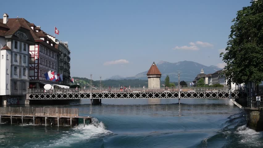 Lucerne, Switzerland view and its medieval architecture. Reuss River in Altstadt (Old Town) with Kapellbrücke (Chapel Bridge) and surrounded by Alps mountains on Lake Lucerne.