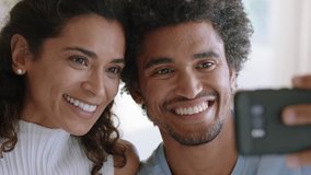 happy mixed race couple using smartphone video chatting to friend smiling excited enjoying online communication