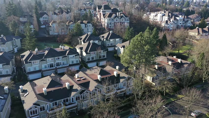 A perfect neighbourhood. Houses in suburb at Summer in the north America. Luxury houses with nice landscape. Aerial drone view. 4K.