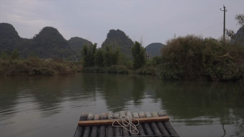 Bamboo raft with a brilliant view of karst mountains in Guilin, Mainland China on the Li River.