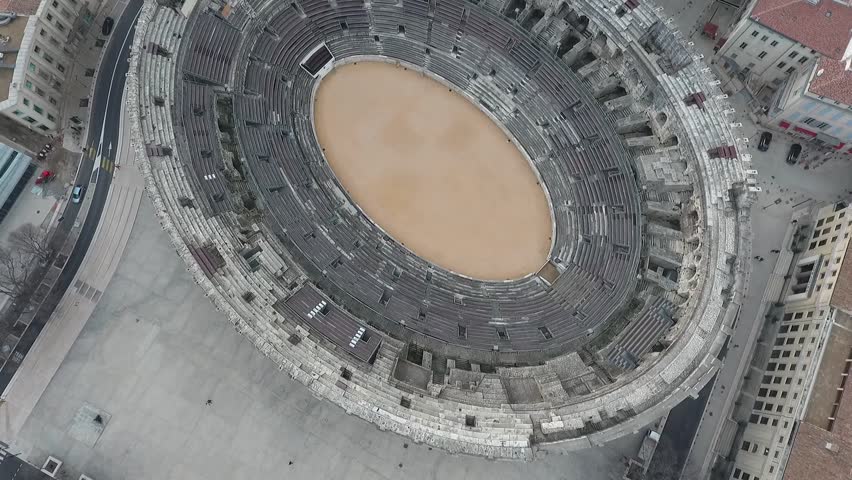 Flying over the old Roman amphitheatre in the city of Nimes, France.
