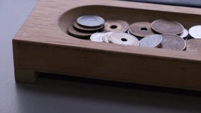 Japanese coin in wooden container by the window.