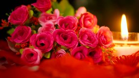 Beautiful flower pink bouquet and candle burning footage. Valentine day