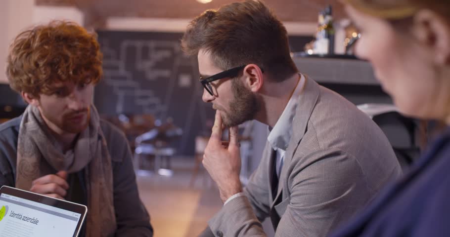 Colleagues and clients talking strategy with laptop and tablet.Group of multiethnic people having informal business team meeting in restaurant lounge.Teamwork,corporate,diversity and social concepts | Shutterstock HD Video #1022451226