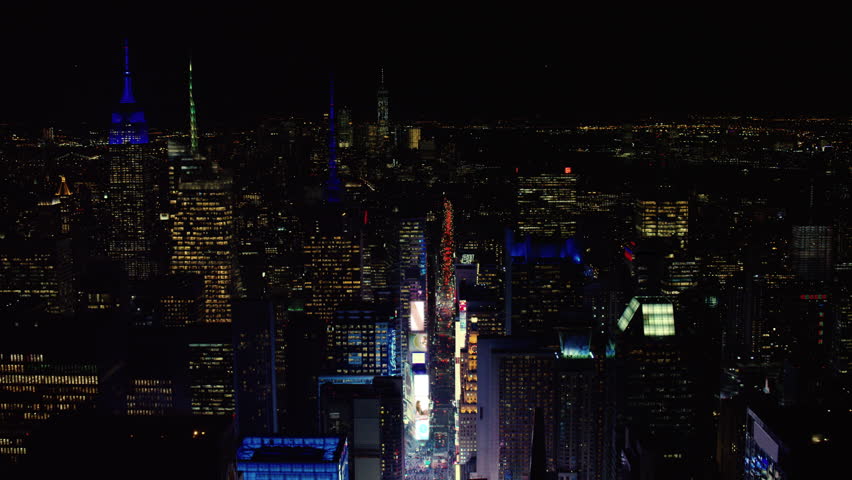 Aerial view of busy streets of Times Square with billboards and advertisements I created, New York City, at night in winter. Shot on 4k RED camera on helicopter Royalty-Free Stock Footage #1022451904