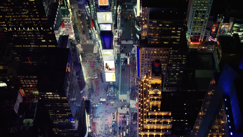 Aerial view of busy streets of Times Square with billboards and advertisements I created, New York City, at night in winter. Shot on 4k RED camera on helicopter