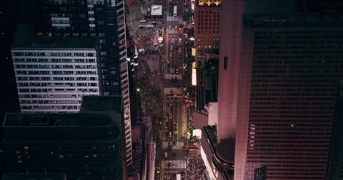 Aerial view of busy streets with vehicles and people in Times Square, New York, with billboards and advertisements I created at night in summer. Shot on 4k RED camera on helicopter