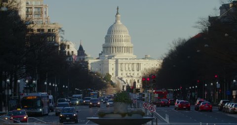 US Capitol Building in winter with traffic along Pennsylvania Avenue. 