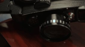 Adjusting film speed control on the 8MM retro movie camera.