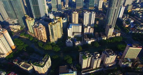 Aerial view of Chengdu City in the morning sunlight, dense residential building near the office building under the blue sky, the Taikoo Li Mall area with traditional Asian style building.