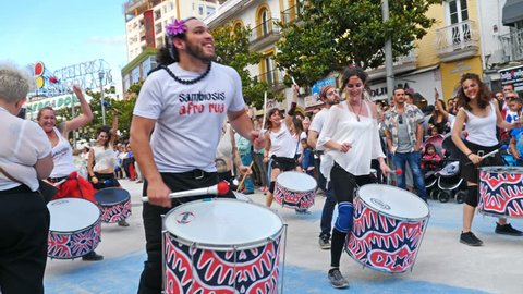 Torremolinos, Spain. Circa June 2018. Group of batucada street drummers in the gay pride parade.Slow motion.
