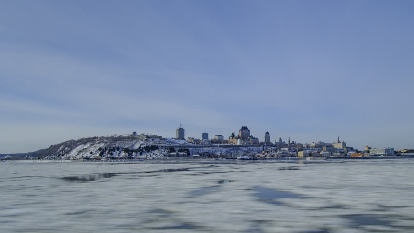Scenic urban timelapse of Frontenac castle on bank of Saint Lawrence river in Quebec province in Quebec-CIty in Canada. Beautiful view of old historic building in center of capital of province.
