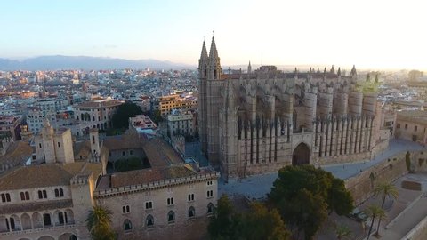 Panoramic aerial drone view over the city of Palma de Mallorca, showing the large cathedral, busy highway, gardens, city skyline. A historic cultural Spanish city in Majorca.