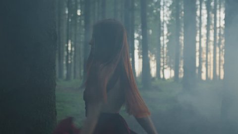 Girl with long hair, in a misty forest.